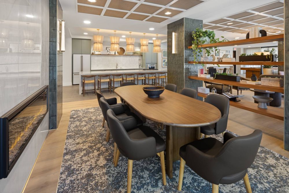 O2 Luxury Tower The Social Lounge fireplace and dining table with chairs