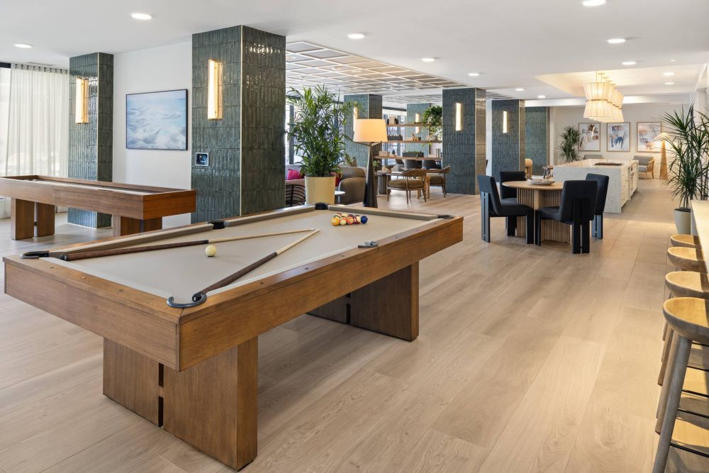 O2 Luxury Tower The Social Lounge with seating, billiards, and shuffleboard