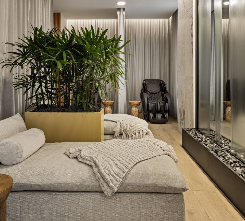 O2 Luxury Towers apartments 22nd terrace outdoor lounge area with large fire put and dining area.
