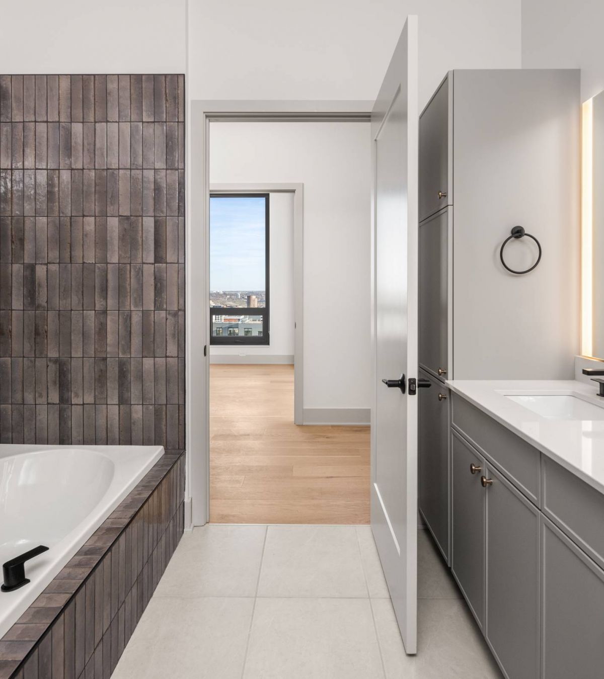 O2 Luxury Tower apartments bathroom with large soaking tub with backsplash and double sink