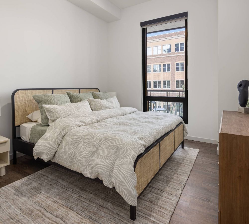 O2 Luxury Towers apartments kitchen with large countertop seating area, gray counters, and modern stainless steel appliances.