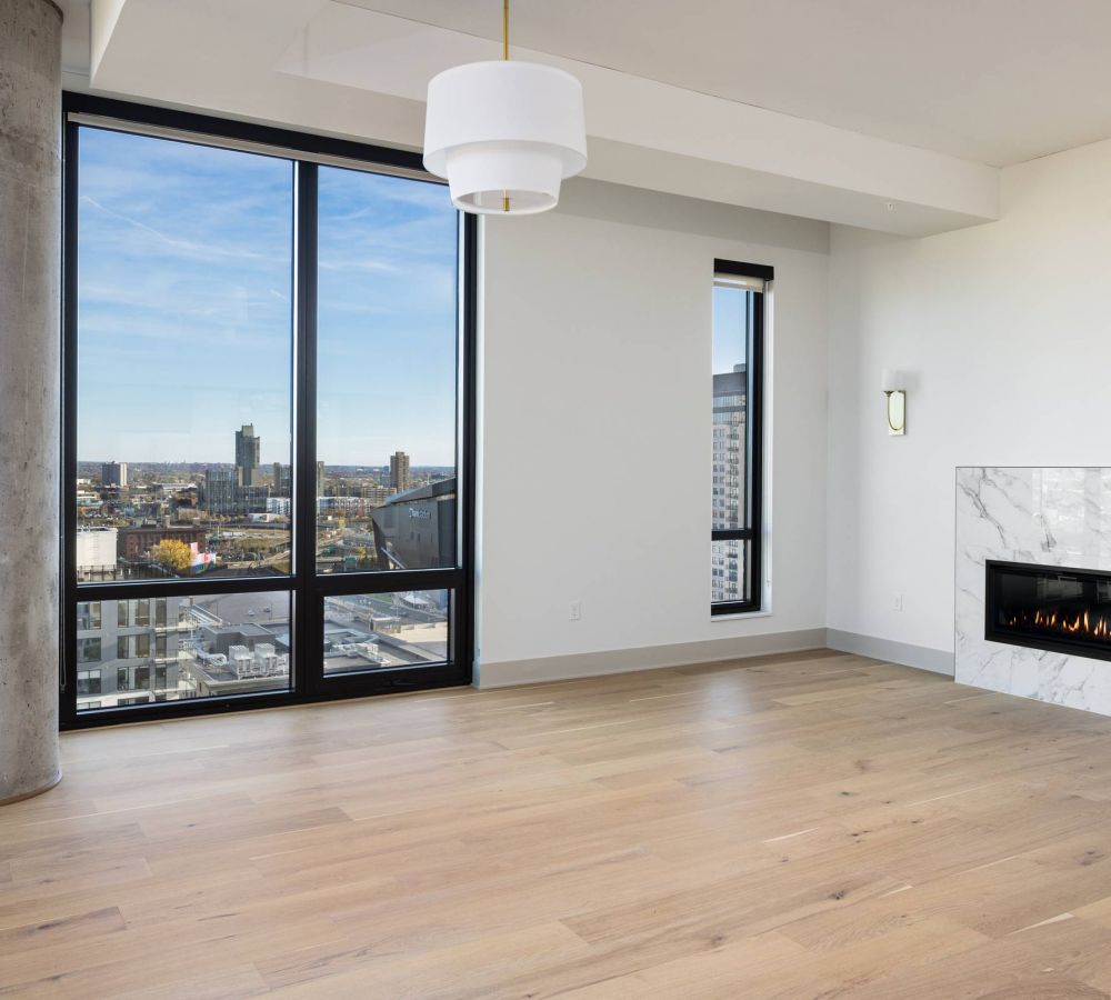 O2 Luxury Tower apartments open floor plan with large windows and fireplace