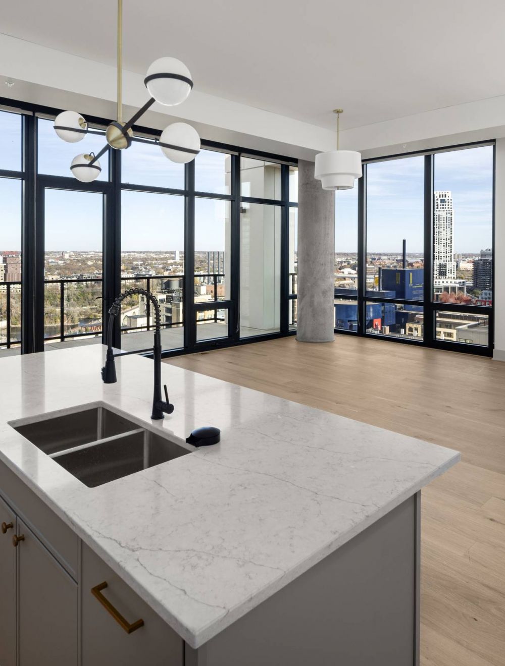 O2 Luxury Tower apartments open floor plan with large kitchen counter and living area