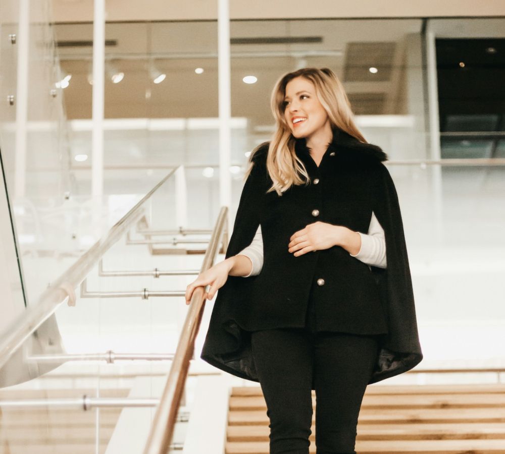 Business woman walking down steps in an office setting